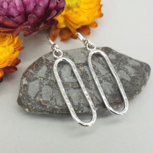 Silver textured ovals suspended from French style ear wires