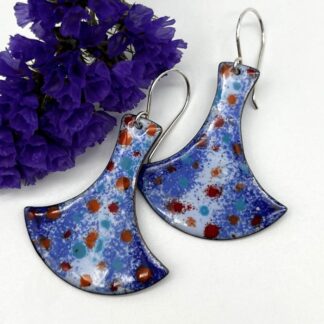 large enamel earrings shaped a little like Thor hammer, in shades of blue with red pattern. on Silver ear wires