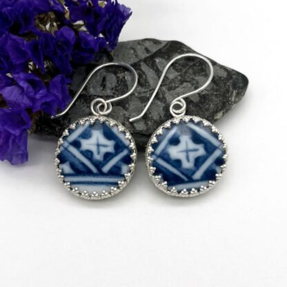 drop silver earrings made set with round pieces of broken blue & white china with a patterned silver surround